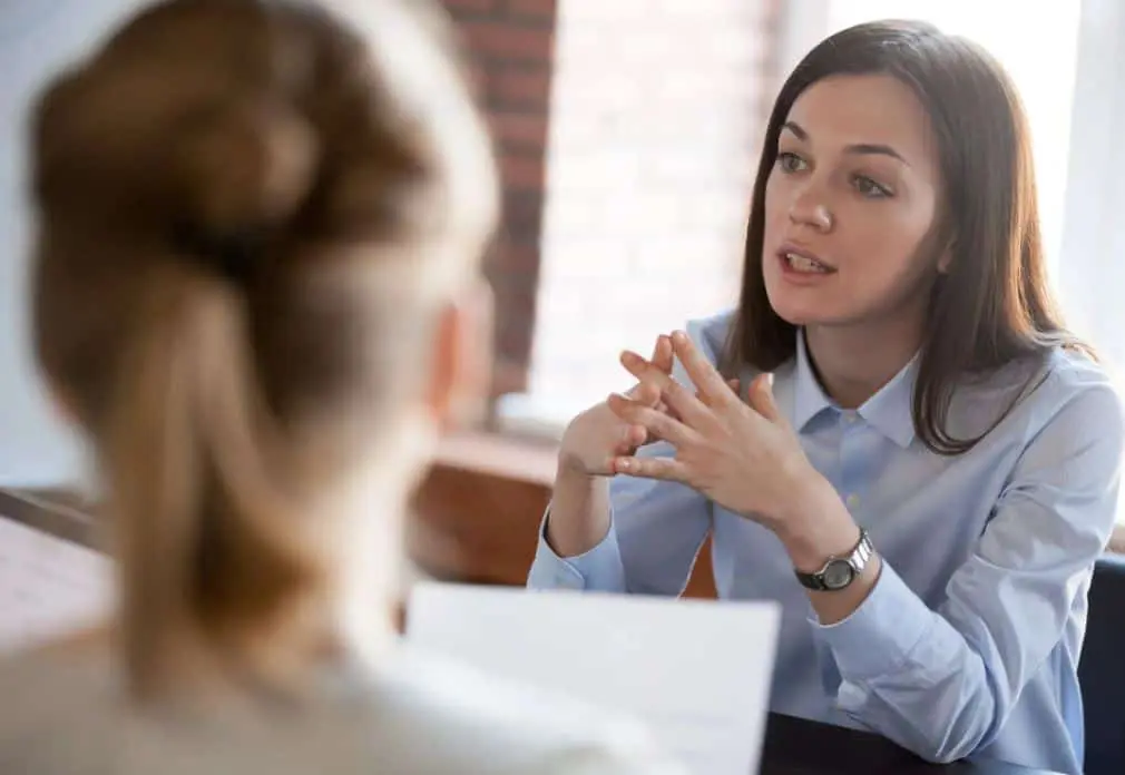 Two women in a professional discussion, representing the personalized guidance and tailored advice provided by the Mantra AI Coaching platform.